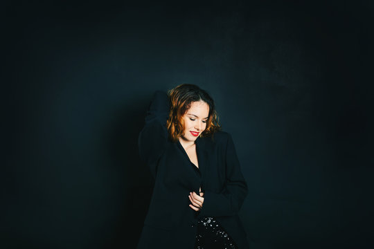 Studio portrait of  fashion glamor woman smiling with red lips on dark background