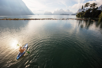 Man traveling by boat at sunset among the islands