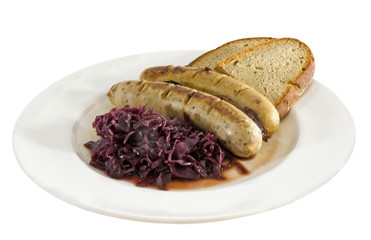 Bratwurst, red cabbage and slices of rye bread on a plate