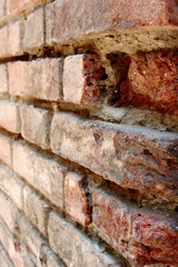 Detail of external wall made of red bricks in Gradara castle, Italy