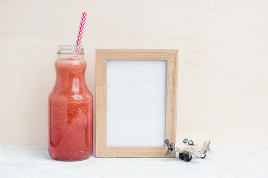 Mock up with Red drink, photo frame and toy airplane