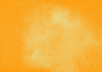 Orange-yellow textured background to the point with spots of paint