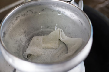 Worker pouring milk into a container for transform.