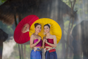 Beautiful girl Thai Lanna women in dress traditional costume with elephant in Chiang Mai, Thailand