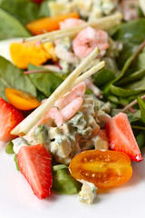 Spring salad with shrimps, egg and strawberry