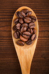 Coffee beans and cinnamon on a background of burlap. Roasted coffee beans background close up. Coffee beans pile from top with copy space for text. Seasoning. Spice. Cinnamon. Badian. Coffee house.