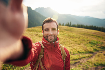 Hiker taking a selfie while out trekking in the wilderness
