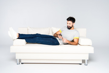 Fototapeta premium Bearded man using smartphone