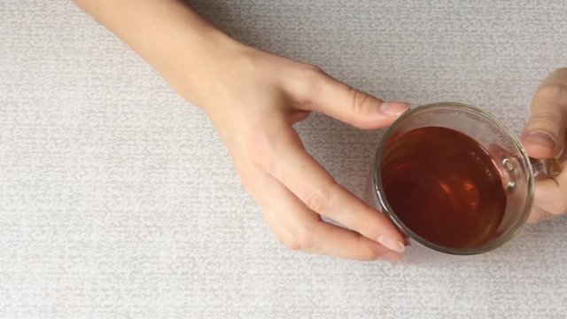 Girl's hands that stir the spoon hot cha