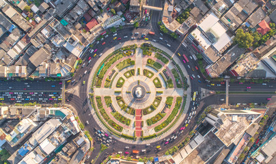 Road roundabout with car lots Wongwian Yai in Bangkok,Thailand. street large beautiful downtown at evening light.  Aerial view , Top view ,cityscape ,Rush hour traffic jam