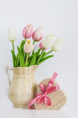 spring concept/bouquet of white and pink tulips, heart shape gift box on a white background vertical