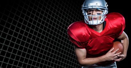 American football player playing against net on black background © vectorfusionart