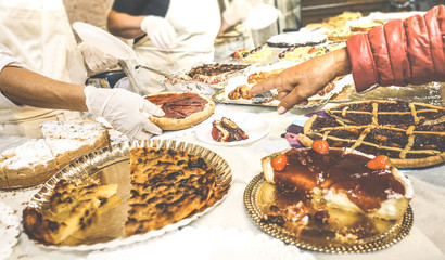 Customer hand choosing slice of pie at pastry confectionery shop - Food concept with homemade cakes and tarts - Warm retro filter