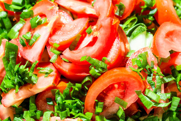 Background of tomato salad with green onions, black pepper and olive oil