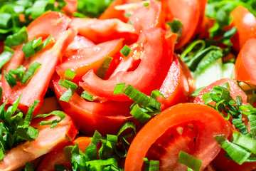 Background of tomato salad with green onions, black pepper and olive oil