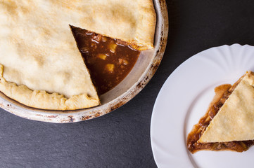 Raw homemade apple pie with cinnamon and walnuts, closeup