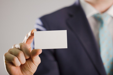 Businessman holding blank Business card