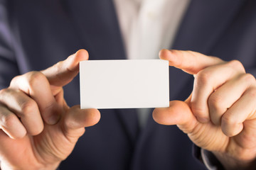 Businessman holding blank Business card