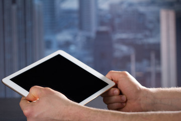 Man witch tablet in office Dubai backbround