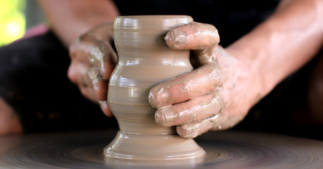 hands working on pottery wheel