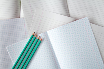 Various exercise books and four pencils