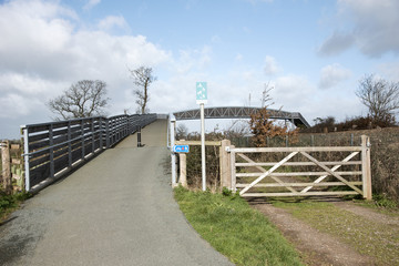 Cycleway and pedestrian foothpath acrooss rail lines to the Exe Estuary footpath near Starcross in South devon England UK