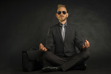 Businessman relaxing in a yoga position