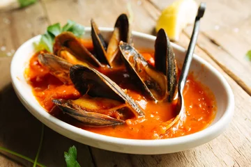 Foto op Canvas Mussel dish cooked in red marinara sauce  © The Outdoor Kids