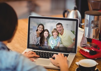 Fototapeta na wymiar Woman having video call with family on laptop