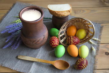 Easter concept. Eggs in the nest jug mug with a piece of bread and a sprig of lavender.
