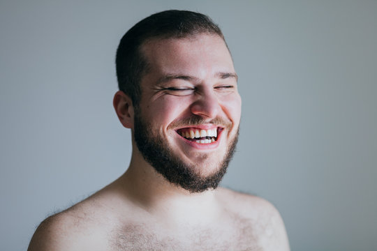 Portrait of young man laughing out loud