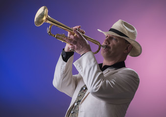 Portrait image of a mature jazz man playing the trumpet