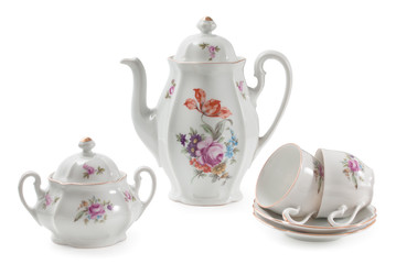 Vintage czech porcelain set for coffee, old style rich decorated by flower decors. There are coffee pot, pair of mugs, saucers, sugar-bowl, isolated on a white background.