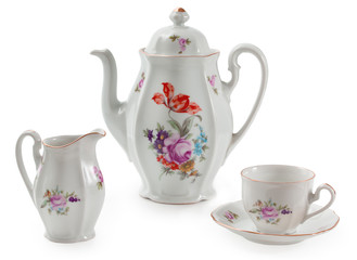 Vintage czech porcelain set for coffee, old style rich decorated by flower decors. There are coffee pot, mug, saucer, creamer, isolated on a white background.