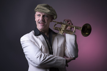 Portrait image of a happy mature jazz man with a trumpet