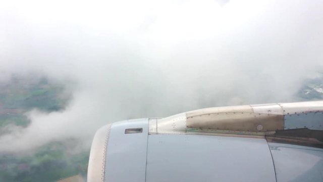 View out of an approaching airliner over its jet engine