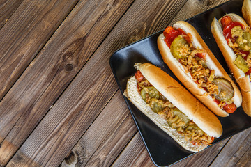 American hot dog with pickles,onions, ketchup and mustard