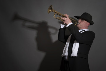 Portrait image of a mature jazz man playing a trumpet 