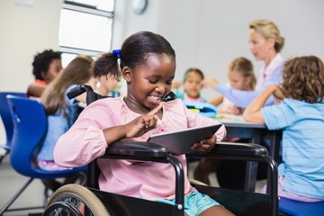 Disabled schoolgirl using digital tablet