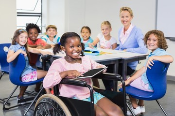 Portrait of teacher and kids in classroom