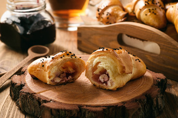 Homemade sweet buns (croissants) with cheese and jam filling.