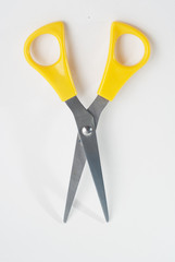 scissors with yellow handles on white background,