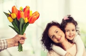 Hand holds flower.