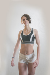 Fototapeta premium beautiful young girl is engaged in sports and fitness on a white background
