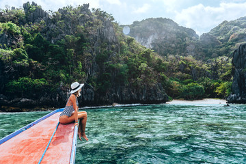 Woman travelling on the boat in Asia - obrazy, fototapety, plakaty