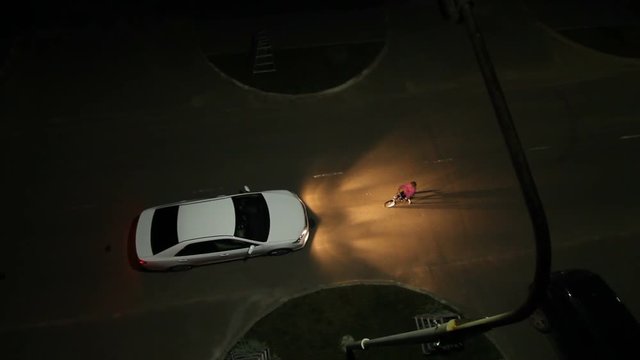 Wideshot Top View Car Headlight to Illuminate  Child on Bicycle