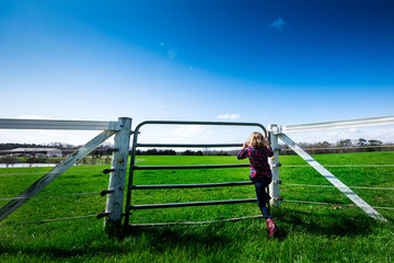 Fence to green grass field on a farm