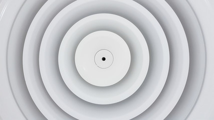 Close up circle air grill on ceiling.