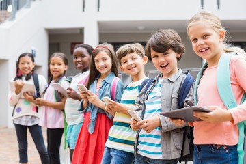 Group of kids using mobile phone and digital tablet