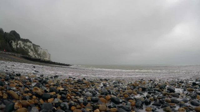 Close up footage of sea waves covering the beach peeble in Dover, Kent, UK
